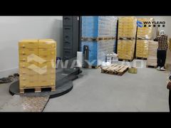 A wrapping machine customized for a food processing plant in Southeast Asia is in operation.